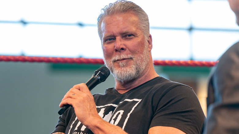 Kevin Nash holding a microphone