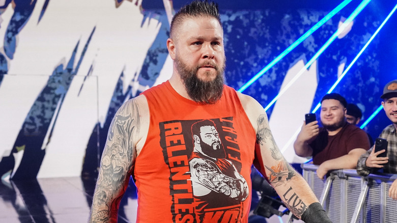 Kevin Owens is wearing a red tanktop.