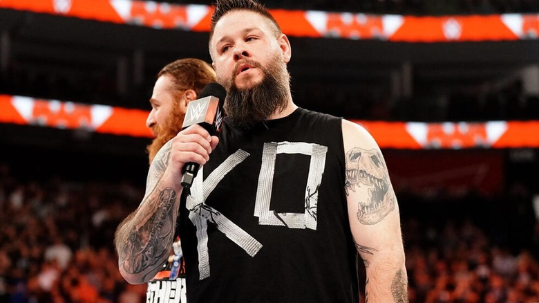 Kevin Owens with microphone (and Sami Zayn)