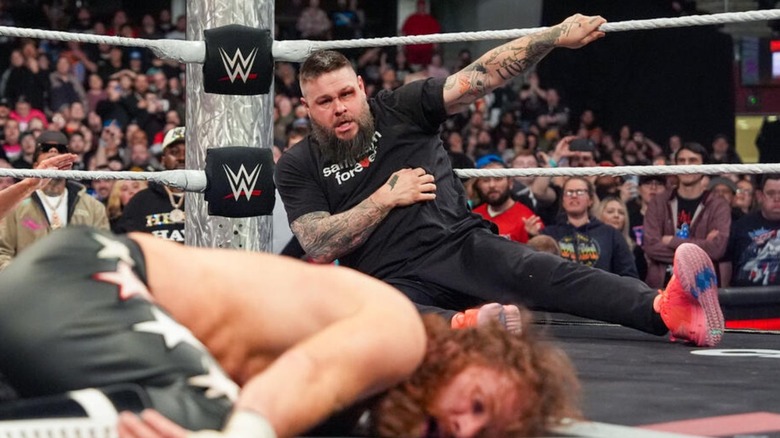 Kevin Owens looks on at a downed Sami Zayn in the middle of the ring after hitting him with a package piledriver to end "WWE Raw."