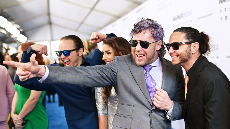 Kenny Omega poses with Young Bucks