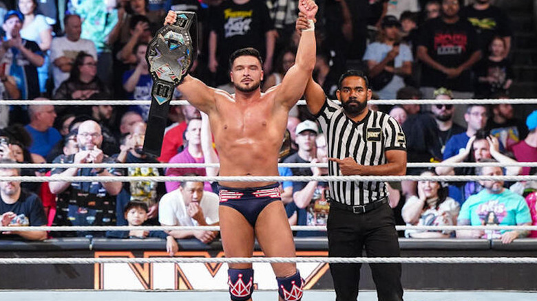 Ethan Page holding up NXT title