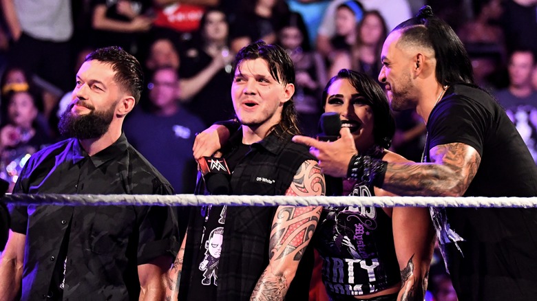 Finn Balor, Dominik Mysterio, Rhea Ripley, and Damian Priest all smiling