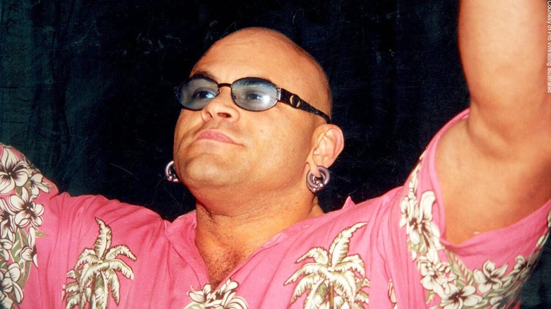 Konnan posing with his arms raised