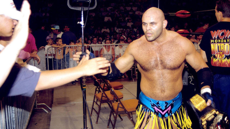 Konnan greets fans after a match