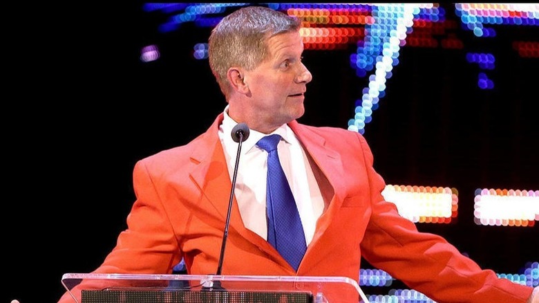 John Laurinaitis at a podium