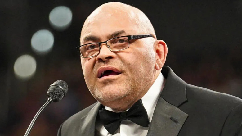 Konnan wearing a black suit