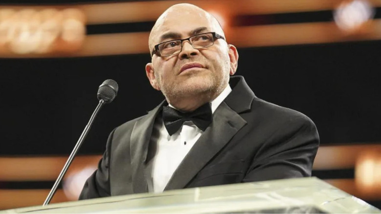 Konnan wearing a black suit