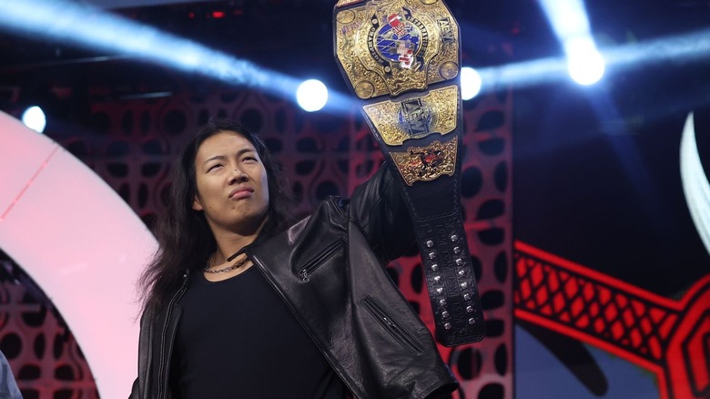 Konosuke Takeshita proudly holds up the AEW International Championship