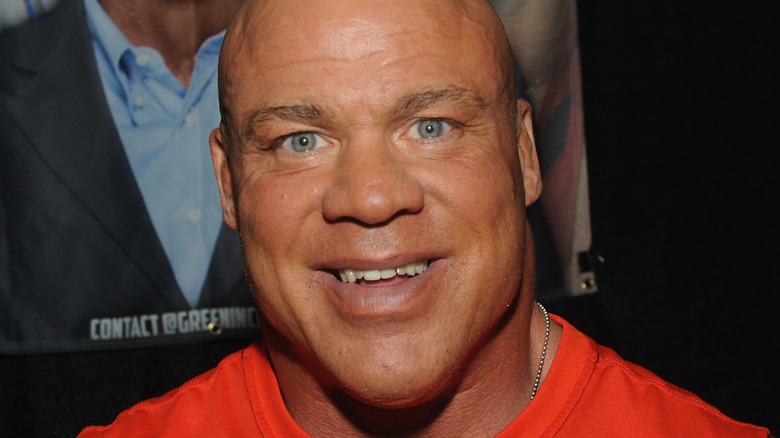 Kurt Angle smiles at a press event 