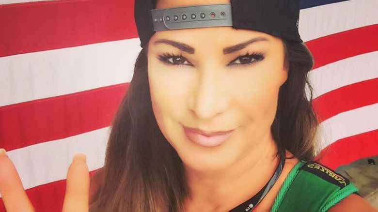 Lisa Marie Varon poses in front of an American flag in a photo posted to her Facebook page.