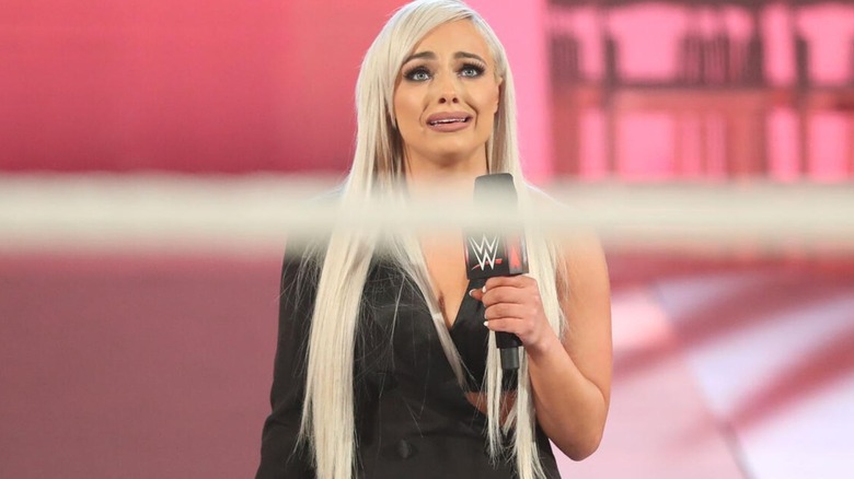 Liv Morgan stands outside the ring, looking in to Lana and Bobby Lashley, returning to WWE during the pair's wedding segment.