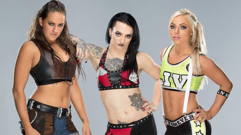 Sarah Logan, Ruby Riott, and Liv Morgan pose for a backstage photoshoot in WWE as the Riott Squad.