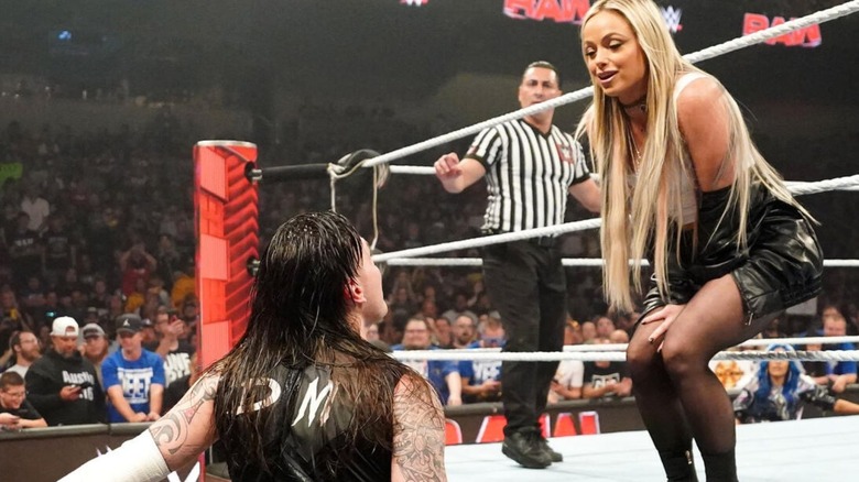 Liv Morgan taunts Dominik Mysterio while standing on the ring apron during an match on "WWE Raw."