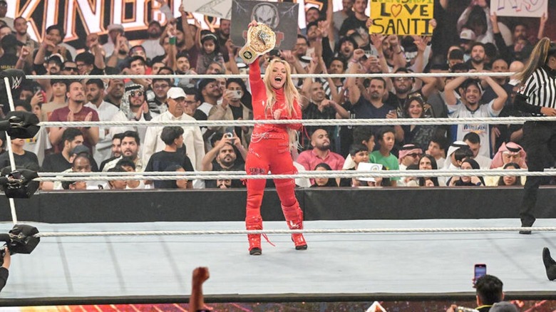 Liv Morgan holds up her newly won Women's World Championship in the ring after defeating Becky Lynch in Saudi Arabia.