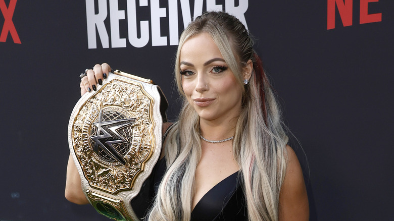 Liv Morgan posing with the title