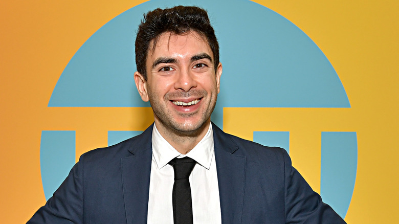 Tony Khan smiles at the camera during a red carpet event