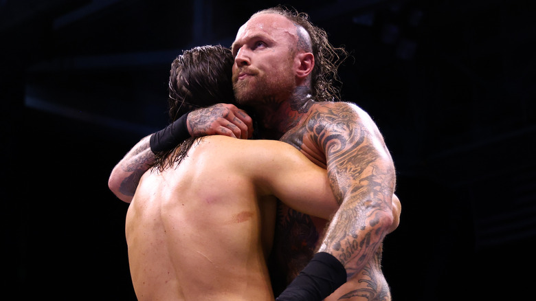 Malakai Black hugging Adam Cole