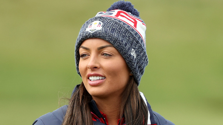 Mandy Rose golfing in a winter hat