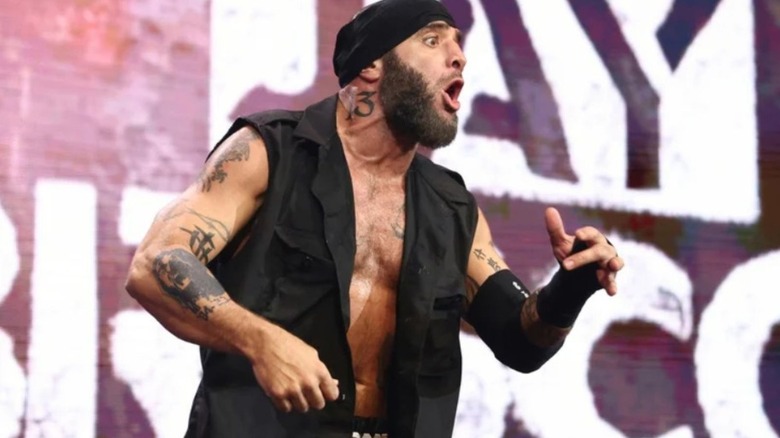 Mark Briscoe stands on the stage and poses