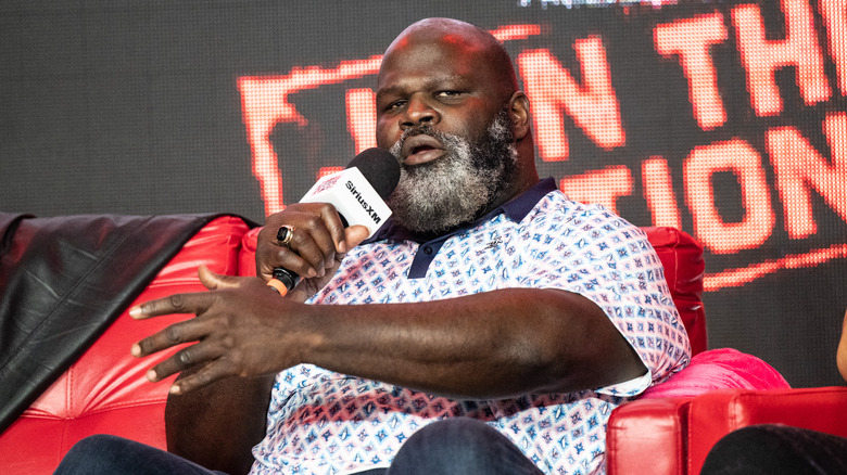 Mark Henry holding a mic