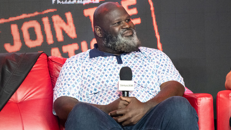 Mark Henry sitting on a red couch