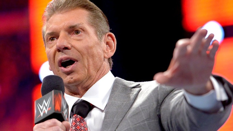 Vince McMahon holds Microphone