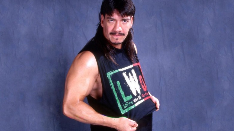 Eddie Guerrero poses backstage in a LWO shirt ahead of a wrestling event.