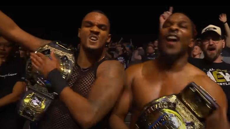 Private Party celebrating with the AEW World Tag Team Titles