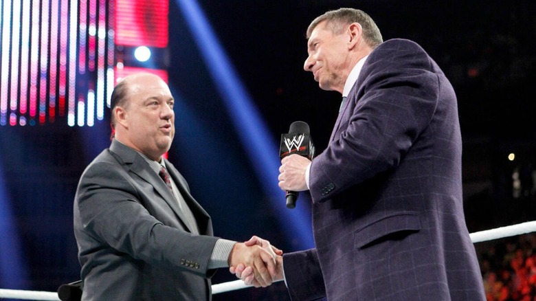 Paul Heyman and Vince McMahon shaking hands in a WWE ring