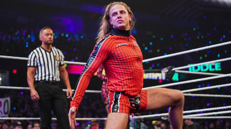 Riddle posing in the middle of the ring 