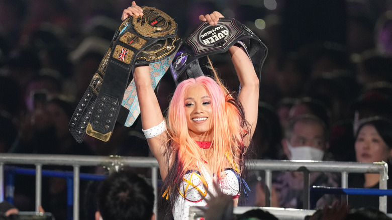 Mercedes Mone celebrates with her four championship belts