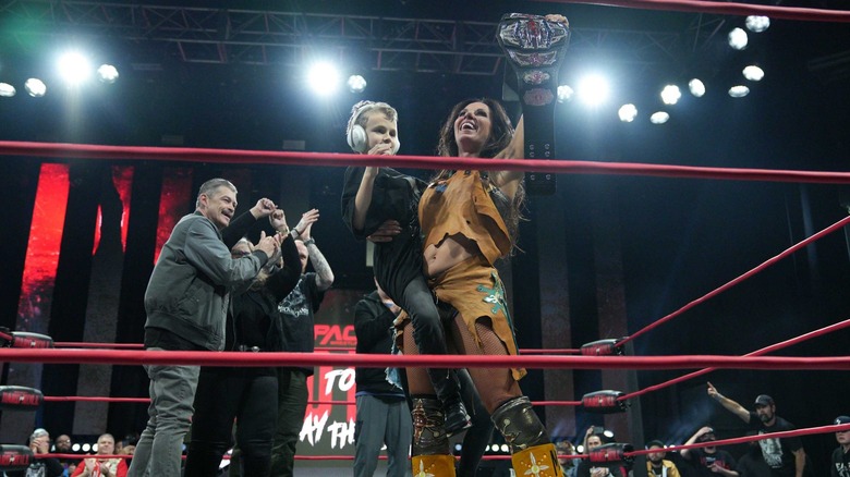 Mickie James holds her son as Knockouts Champion