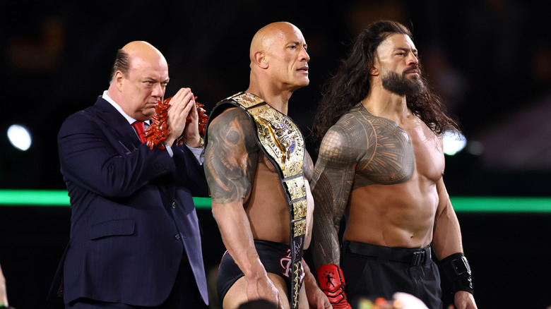 Paul Heyman, Dwayne "The Rock" Johnson and Roman Reigns look on following a fight against Cody Rhodes and Seth "Freakin" Rollins during Night One of WrestleMania 40 at Lincoln Financial Field on April 06, 2024 in Philadelphia, Pennsylvania.