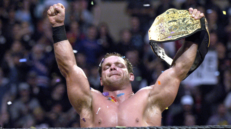 Chris Benoit stands in the ring and raises the World Heavyweight Championship after his victory at WrestleMania.