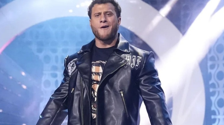 MJF heads to the ring to cut a promo upon his return to AEW, wearing a leather jacket.