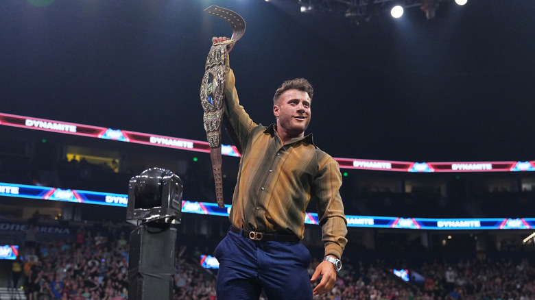 MJF smiles while holding his title belt high
