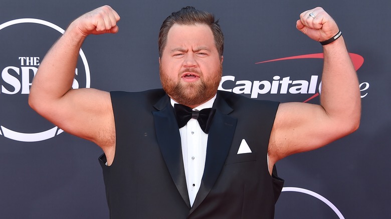 Paul Walter Hauser flexes