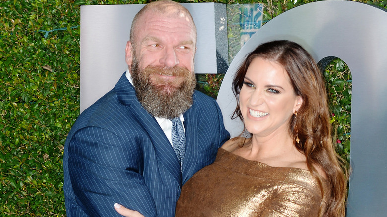 Triple H poses with Stephanie McMahon