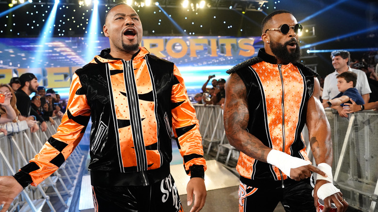 Angelo Dawkins and Montez Ford are wearing orange and black ring gear