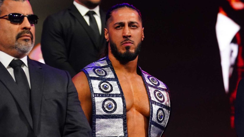 Mustafa Ali in TNA Wrestling flanked by bodyguards