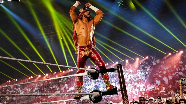 Mustafa Ali poses on the turnbuckle during a WWE event in Saudi Arabia.