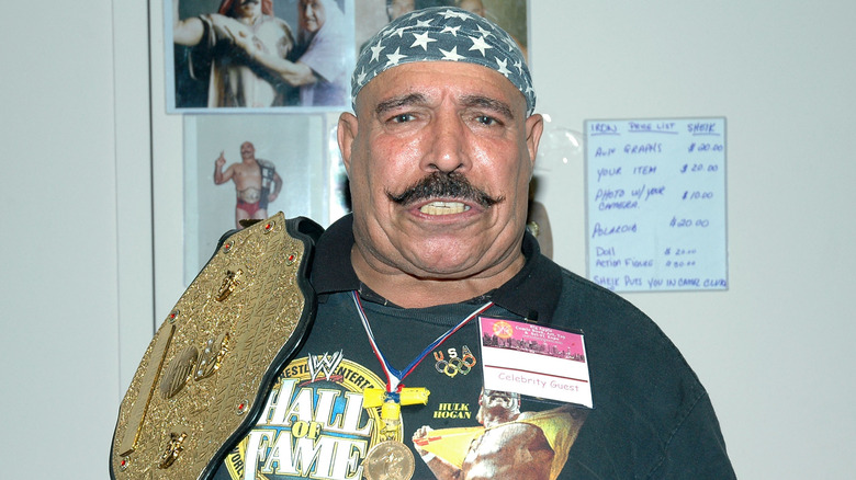 The Iron Sheik with World Heavyweight Championship on his shoulder