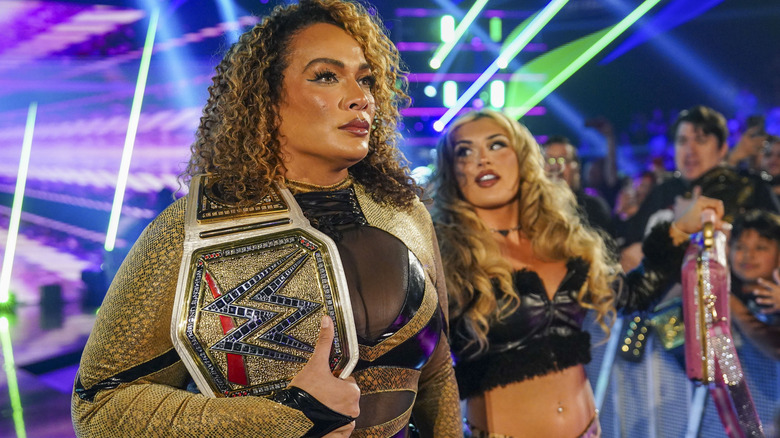 Nia Jax standing beside Tiffany Stratton