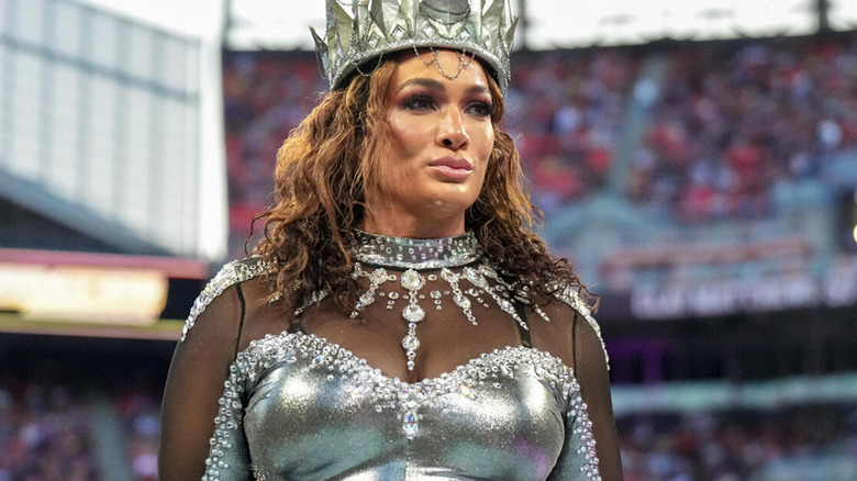 Nia Jax stands regally with her crown and silver ring gear.