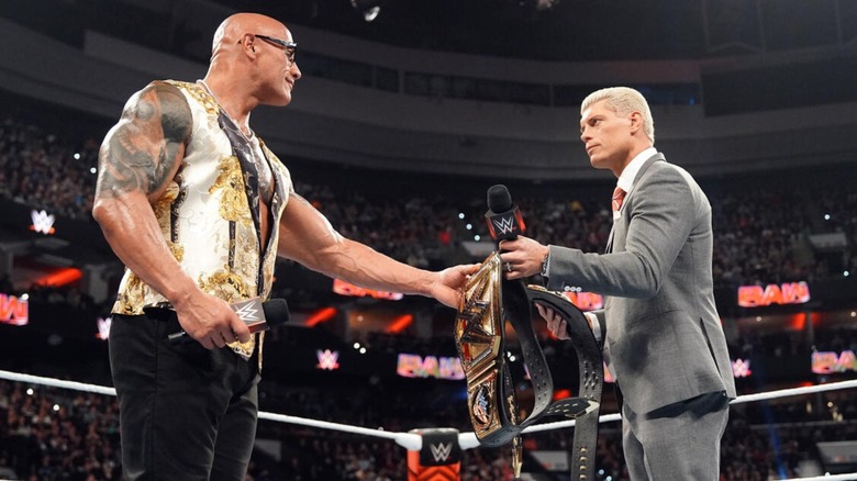 Dwayne "The Rock" Johnson and Cody Rhodes exchange belts on WWE Raw