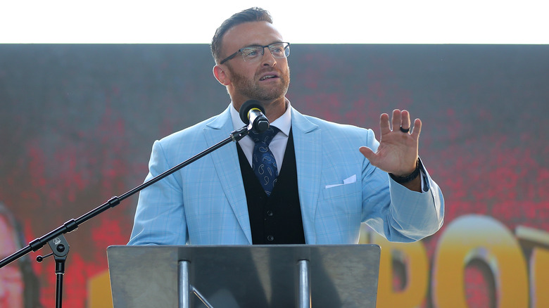 Nick Aldis speaks at podium