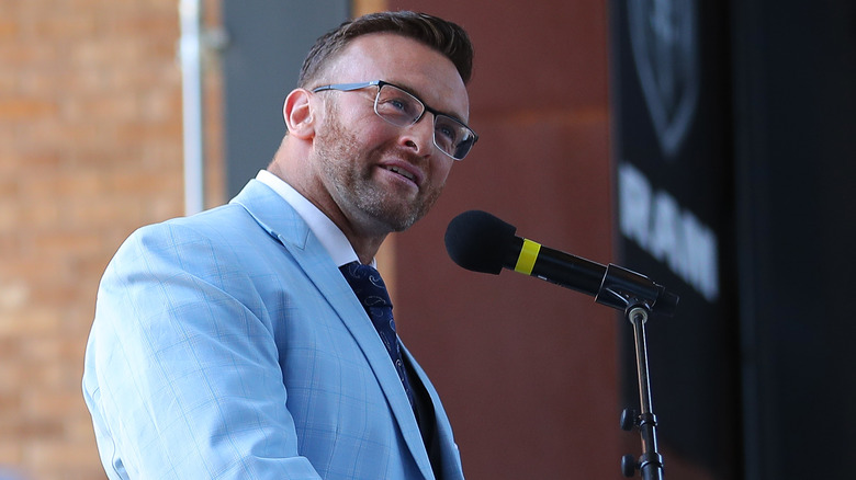 Nick Aldis speaking at a podium