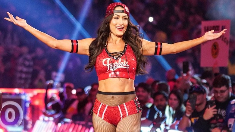 Nikki Bella wearing a red, bedazzled snapback hat