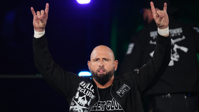 NEVER Openweight Champion Karl Anderson with arms up